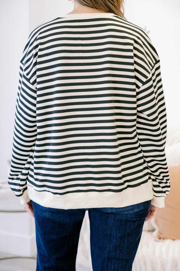 Chic Soul plus size clothing, black long sleeve pullover with white stripe pattern and ribbon bow detailing with round neckline and cuffed sleeves with white band along the bottom