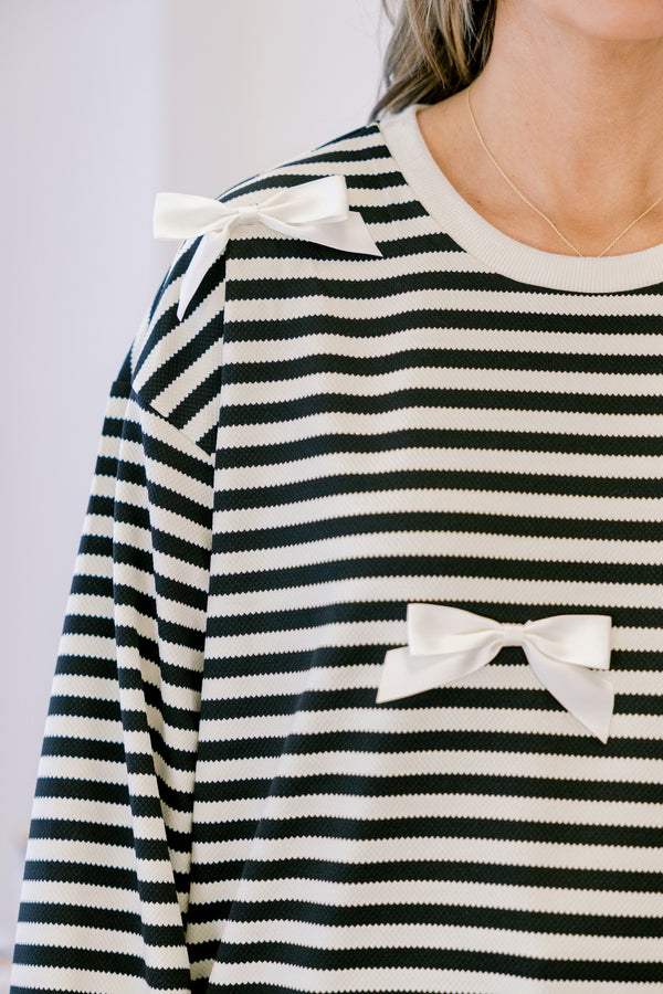 Chic Soul plus size clothing, black long sleeve pullover with white stripe pattern and ribbon bow detailing with round neckline and cuffed sleeves with white band along the bottom