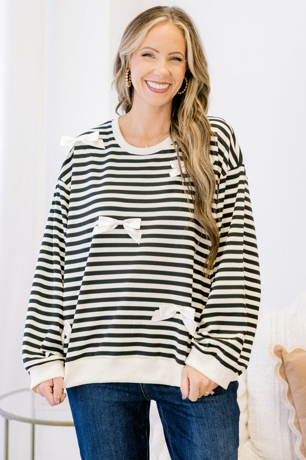 Chic Soul plus size clothing, black long sleeve pullover with white stripe pattern and ribbon bow detailing with round neckline and cuffed sleeves with white band along the bottom