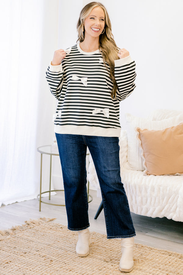 Chic Soul plus size clothing, black long sleeve pullover with white stripe pattern and ribbon bow detailing with round neckline and cuffed sleeves with white band along the bottom