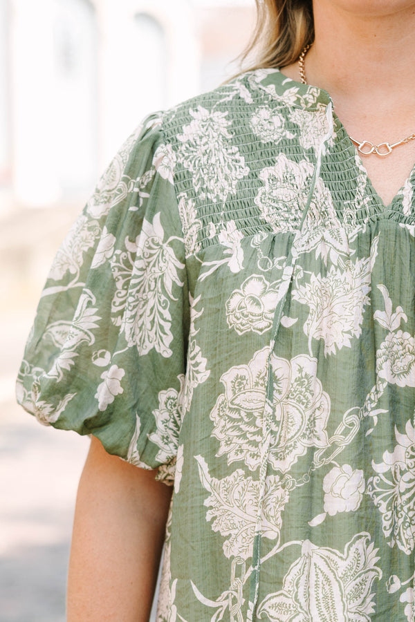 Plus Size green floral print top with elastic puff sleeves, split v-neck, and smocked shoulders.