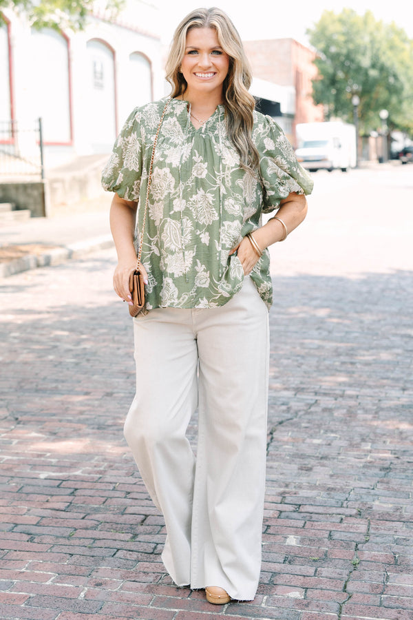 Plus Size green floral print top with elastic puff sleeves, split v-neck, and smocked shoulders.