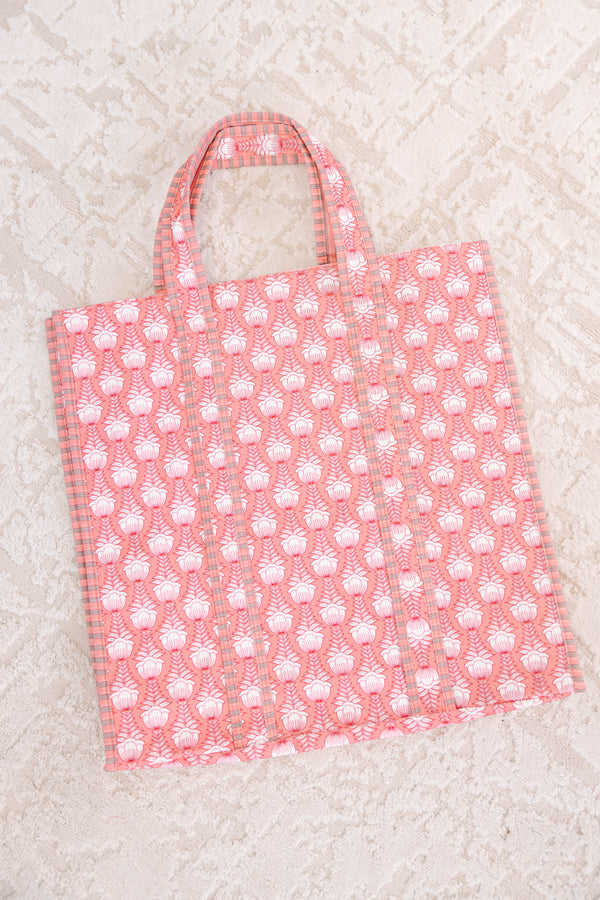 Plus Size pink quilted tote bag with a white botanical print and matching top handles.