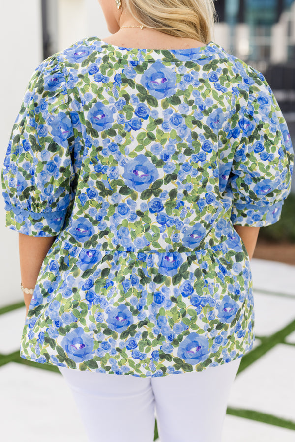 Chic Soul plus size clothing, blue short sleeve top with a green and blue floral pattern as well as scalloped stitching details along the bottom of the sleeves and along the v-neckline 
