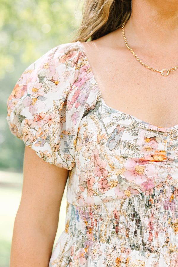Plus Size pink floral maxi dress with puff sleeves, a smocked waist, and a tiered skirt.