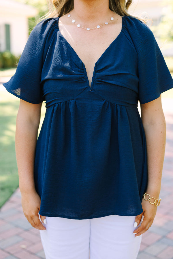 Plus Size navy blue V-neck top with flutter sleeves, a gathered bust, and a flowy peplum hem.