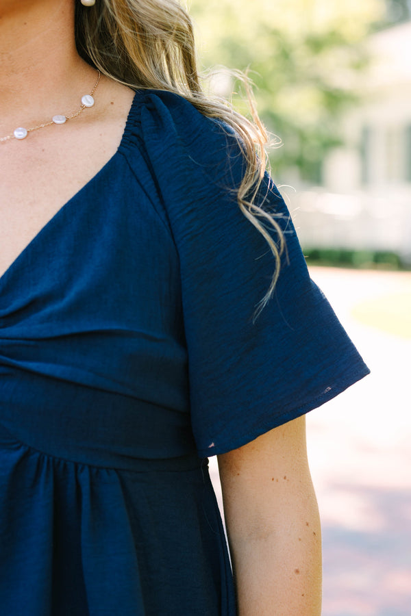 Plus Size navy blue V-neck top with flutter sleeves, a gathered bust, and a flowy peplum hem.