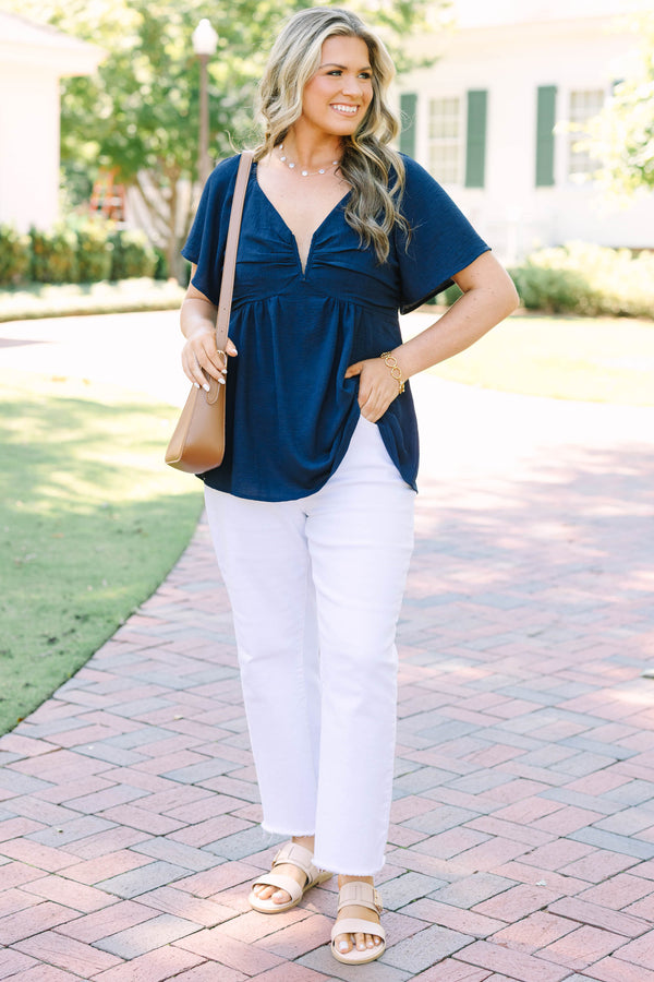 Plus Size navy blue V-neck top with flutter sleeves, a gathered bust, and a flowy peplum hem.