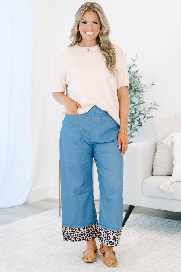Plus size denim cropped pants with a wide leg fit and bold leopard print cuffed ankles.