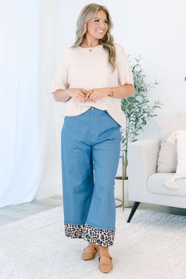 Plus size denim cropped pants with a wide leg fit and bold leopard print cuffed ankles.