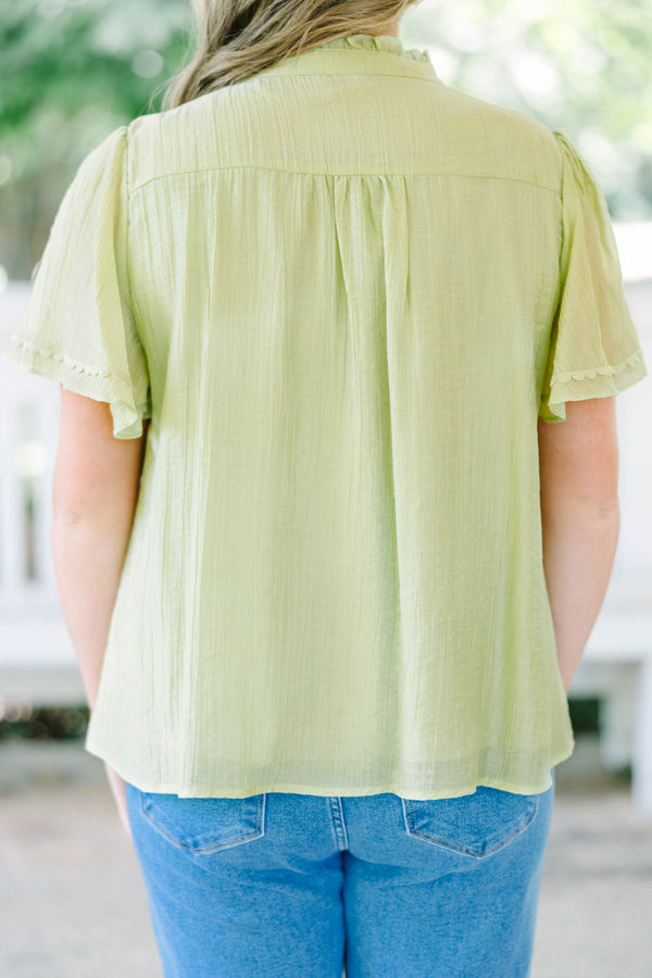 Plus Size light green textured top with a ruffled V-neckline, short flutter sleeves, and lace trim.