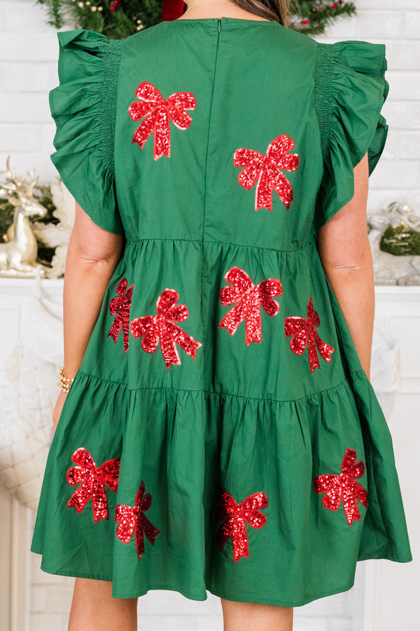 Chic Soul plus size clothing, short-flutter-sleeve green ruffled baby doll dress with red sequin bow patches scattered across dress 