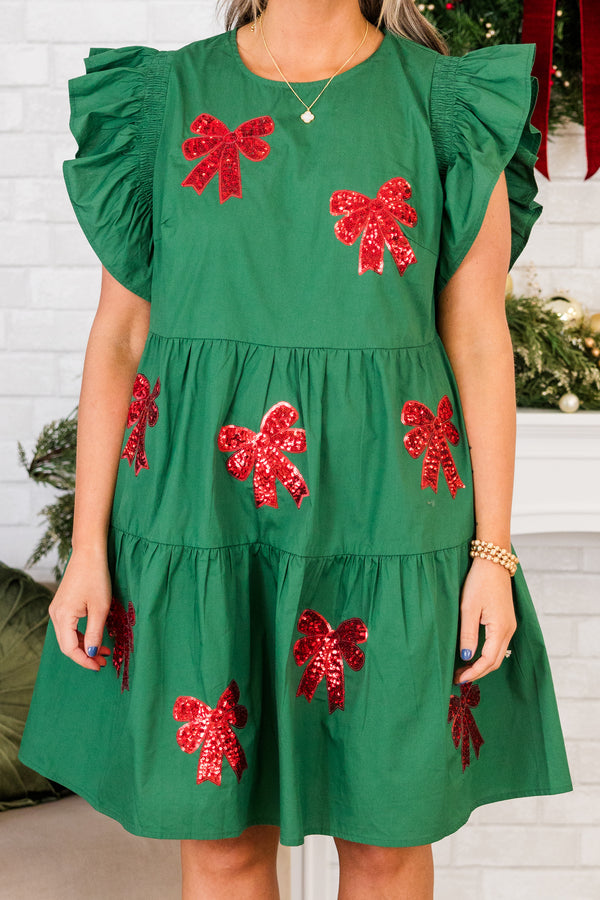 Chic Soul plus size clothing, short-flutter-sleeve green ruffled baby doll dress with red sequin bow patches scattered across dress 