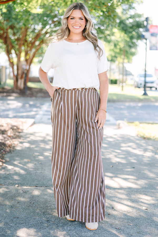 Plus size brown and white vertical stripe wide-leg pants in a flowy rayon fabric.