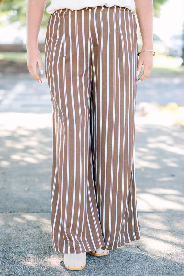 Plus size brown and white vertical stripe wide-leg pants in a flowy rayon fabric.