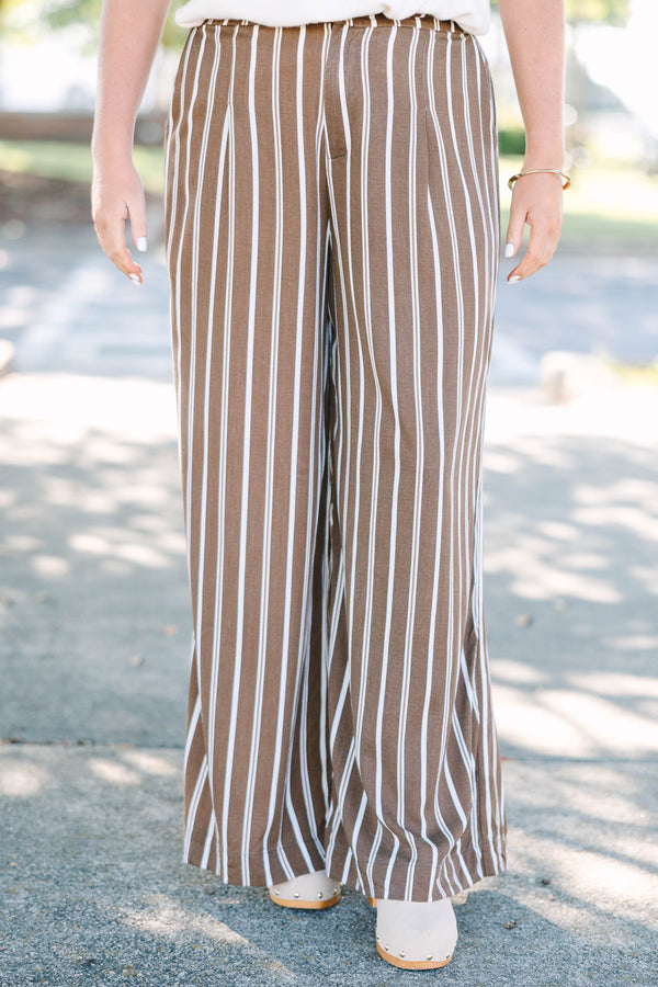 Plus size brown and white vertical stripe wide-leg pants in a flowy rayon fabric.