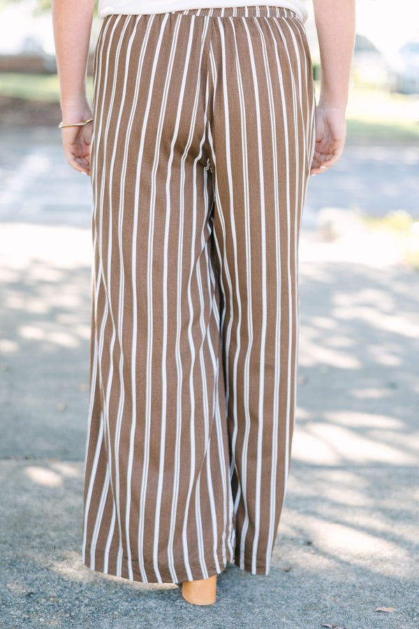 Plus size brown and white vertical stripe wide-leg pants in a flowy rayon fabric.
