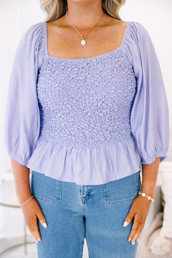 Plus Size lavender smocked top with a square neckline, puff sleeves, and a peplum hem.