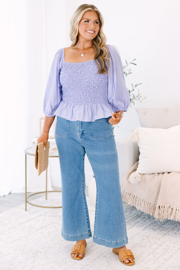 Plus Size lavender smocked top with a square neckline, puff sleeves, and a peplum hem.
