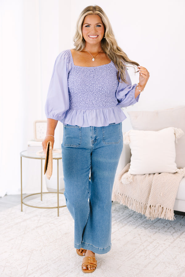 Plus Size lavender smocked top with a square neckline, puff sleeves, and a peplum hem.