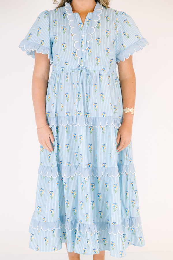 Chic Soul plus size clothing, blue maxi  dress with a floral pattern and scalloped ruffle detailing on the ends of the sleeves going down the v-neckline and on each tier of the dress as well as a bow that ties under the chest area 