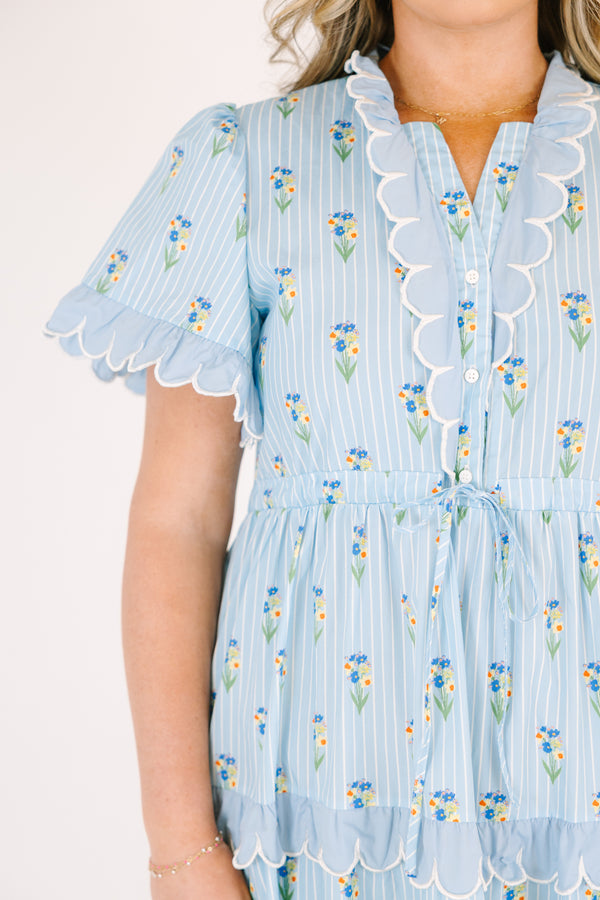 Chic Soul plus size clothing, blue maxi  dress with a floral pattern and scalloped ruffle detailing on the ends of the sleeves going down the v-neckline and on each tier of the dress as well as a bow that ties under the chest area 
