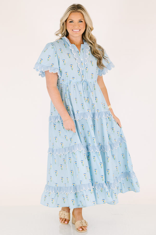 Chic Soul plus size clothing, blue maxi  dress with a floral pattern and scalloped ruffle detailing on the ends of the sleeves going down the v-neckline and on each tier of the dress as well as a bow that ties under the chest area 