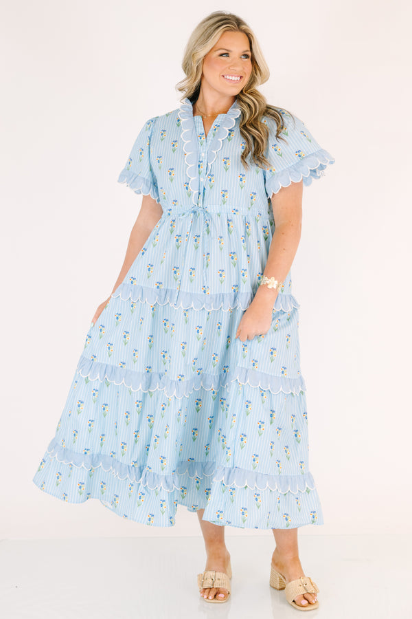 Chic Soul plus size clothing, blue maxi  dress with a floral pattern and scalloped ruffle detailing on the ends of the sleeves going down the v-neckline and on each tier of the dress as well as a bow that ties under the chest area 
