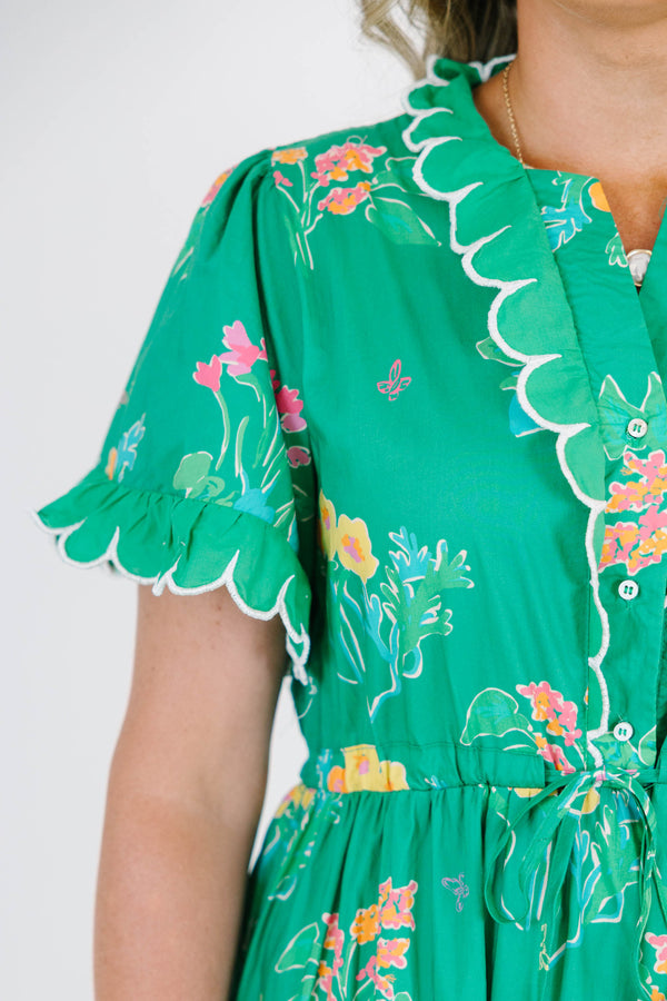 Plus Size green tiered midi dress with floral print, scalloped trim, and short flutter sleeves.