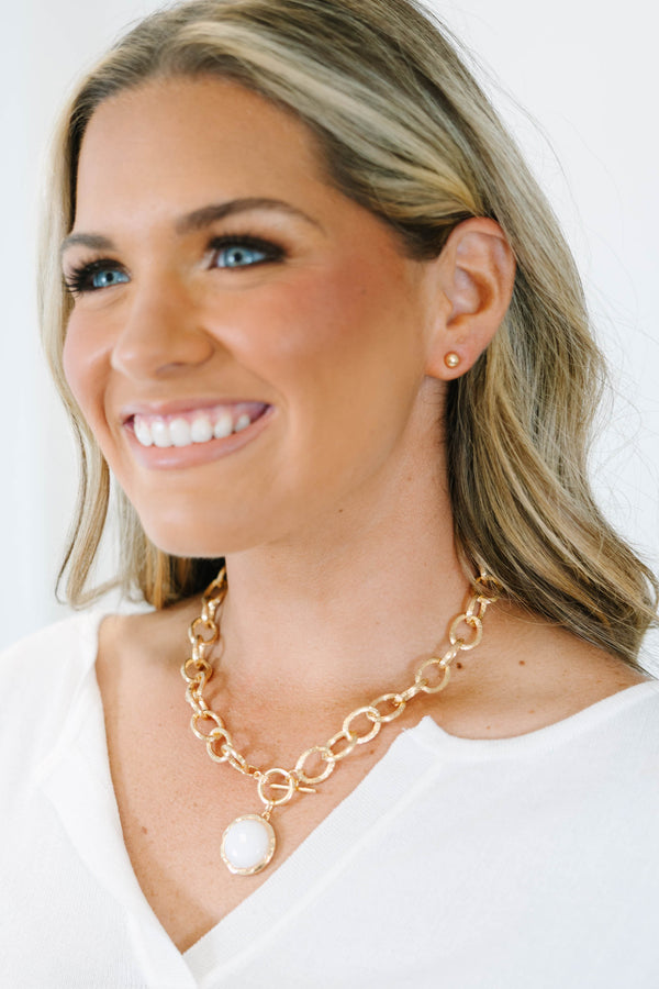 Plus Size gold chain link necklace with a white stone pendant and matching gold stud earrings.