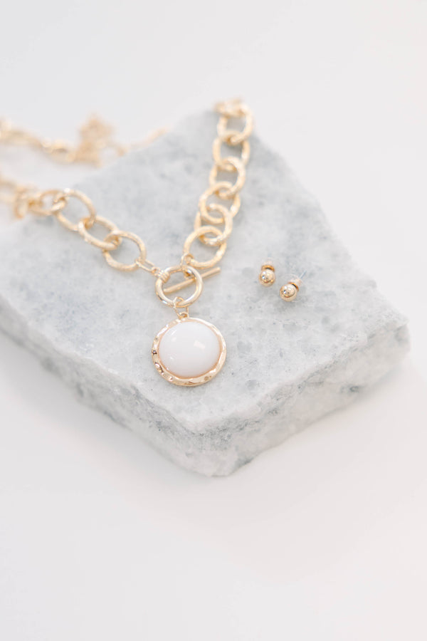 Plus Size gold chain link necklace with a white stone pendant and matching gold stud earrings.