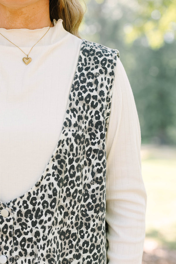 Plus Size leopard print button-front jumper dress over a white long-sleeve turtleneck top.