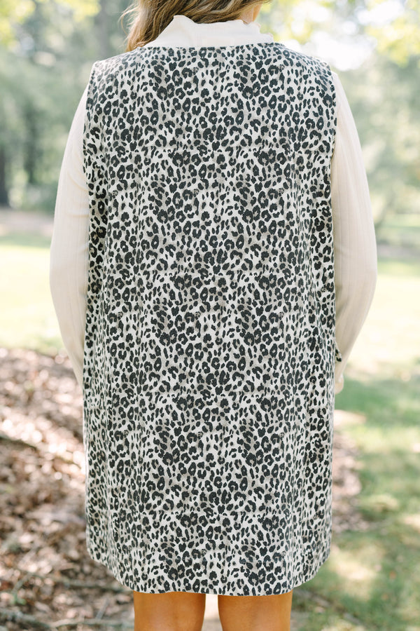Plus Size leopard print button-front jumper dress over a white long-sleeve turtleneck top.