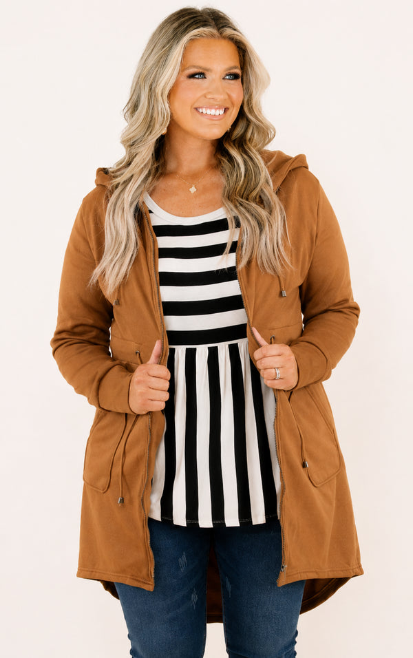 Plus Size camel hooded zip-up jacket with a drawstring waist over a black and white striped top.