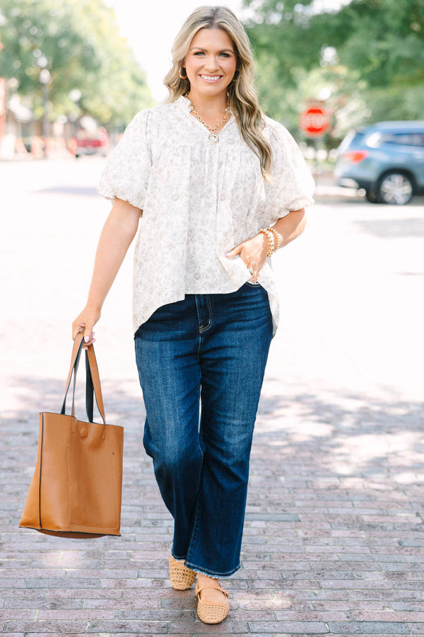 Plus Size cream floral blouse with a ruffled v-neckline and short elastic bubble sleeves.