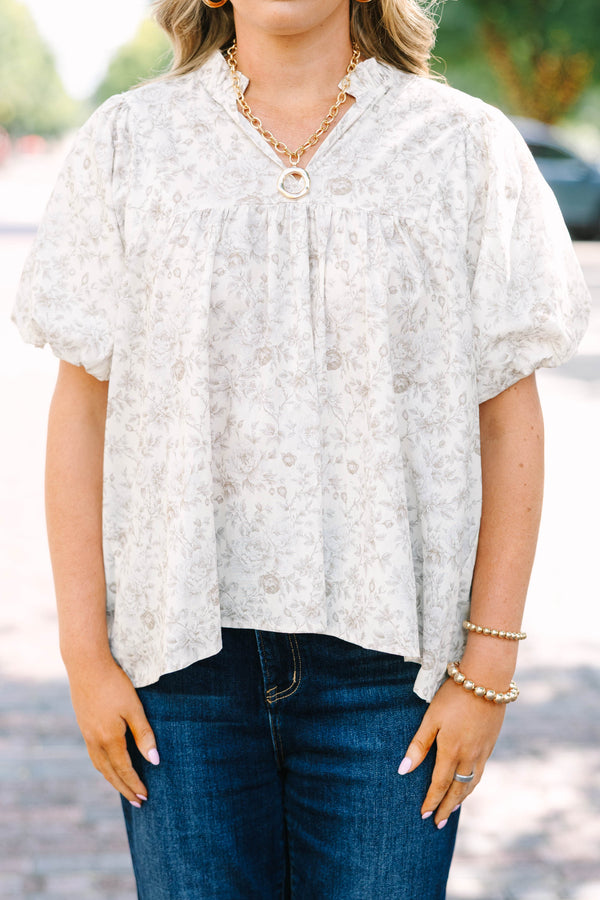 Plus Size cream floral blouse with a ruffled v-neckline and short elastic bubble sleeves.