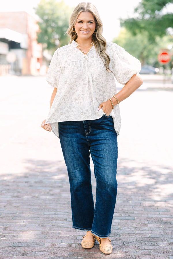 Plus Size cream floral blouse with a ruffled v-neckline and short elastic bubble sleeves.