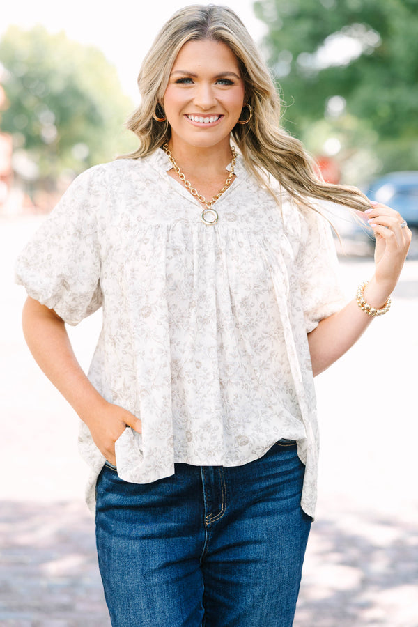 Plus Size cream floral blouse with a ruffled v-neckline and short elastic bubble sleeves.