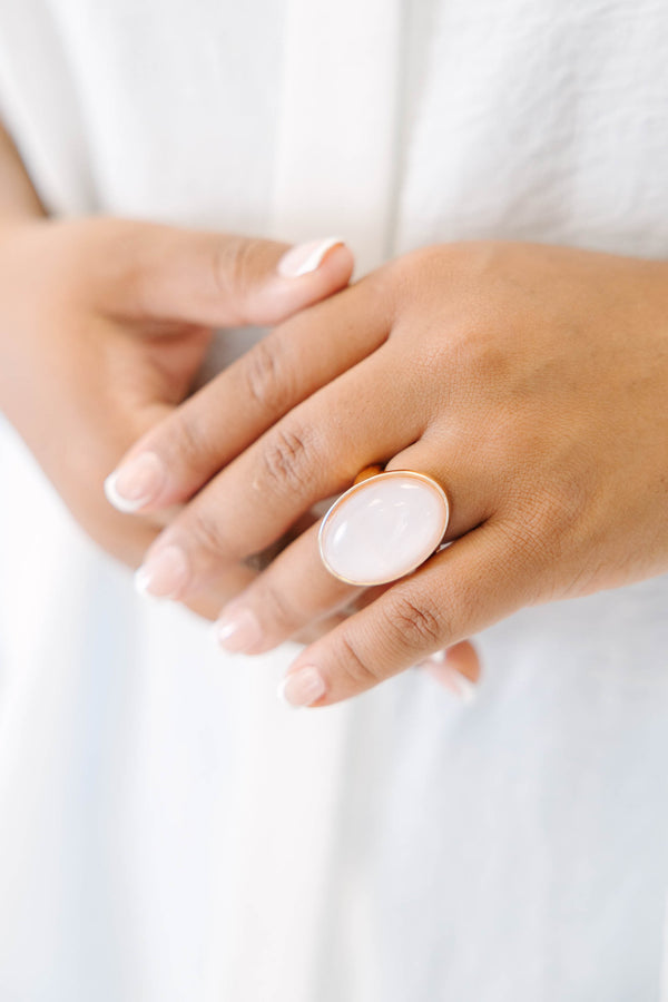 Plus Size gold-plated ring featuring a large, oval, luminous light pink stone.