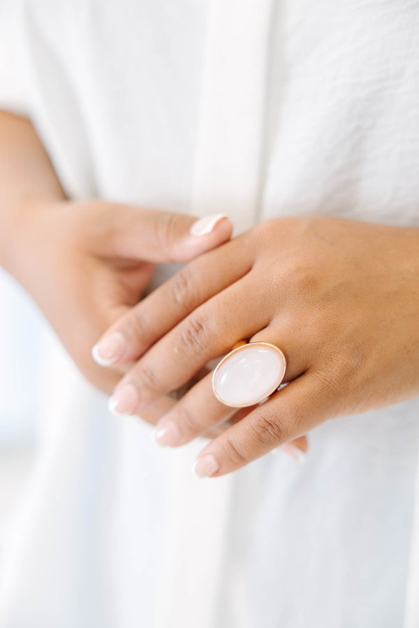 Plus Size gold-plated ring featuring a large, oval, luminous light pink stone.