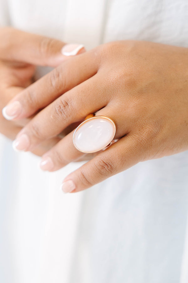 Plus Size gold-plated ring featuring a large, oval, luminous light pink stone.
