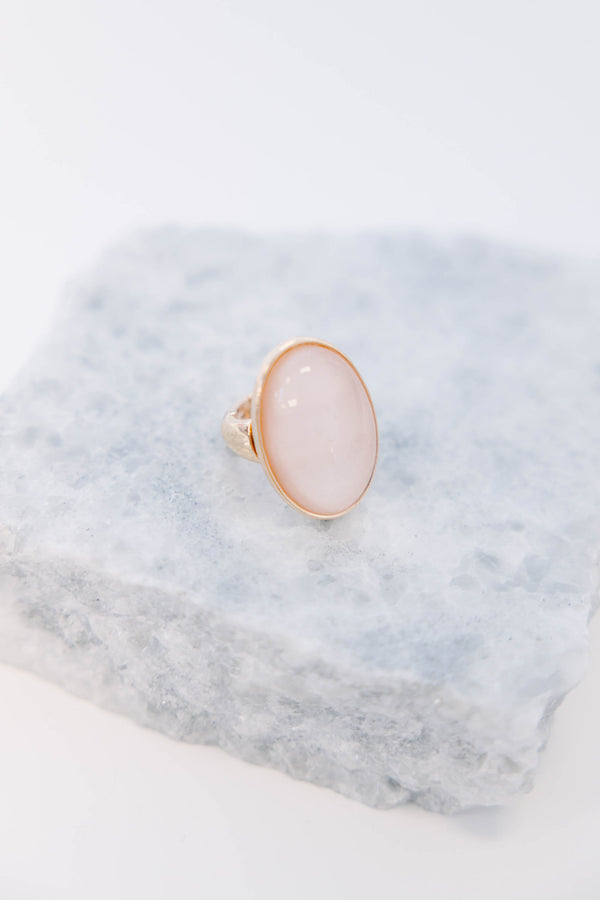 Plus Size gold-plated ring featuring a large, oval, luminous light pink stone.