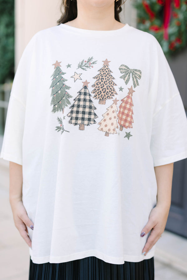 Plus Size ivory boyfriend tee with Christmas tree graphics and a black pleated skirt.