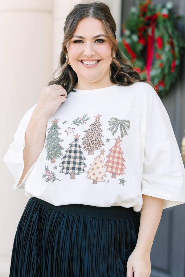 Plus Size ivory boyfriend tee with Christmas tree graphics and a black pleated skirt.
