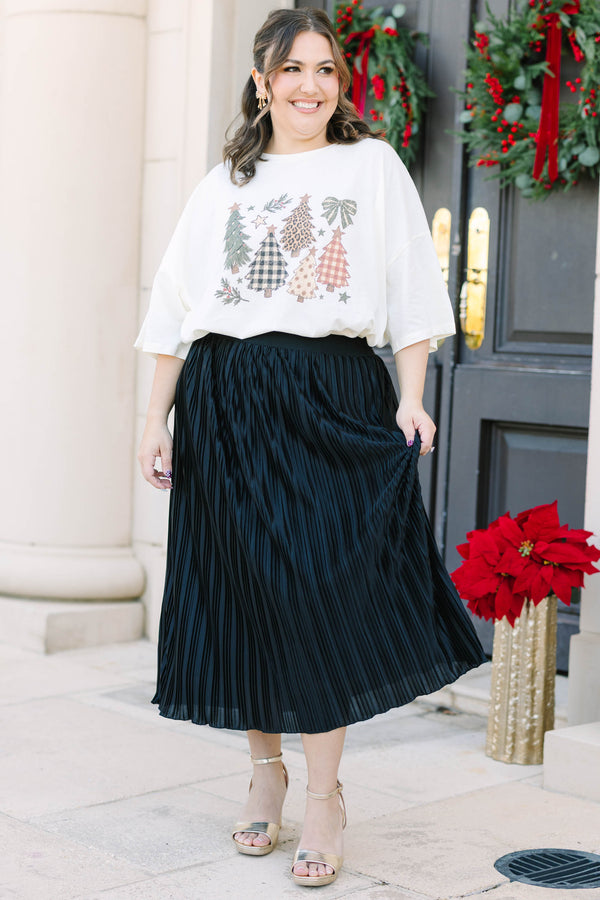 Plus Size ivory boyfriend tee with Christmas tree graphics and a black pleated skirt.