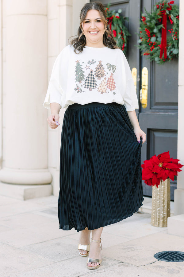 Plus Size ivory boyfriend tee with Christmas tree graphics and a black pleated skirt.