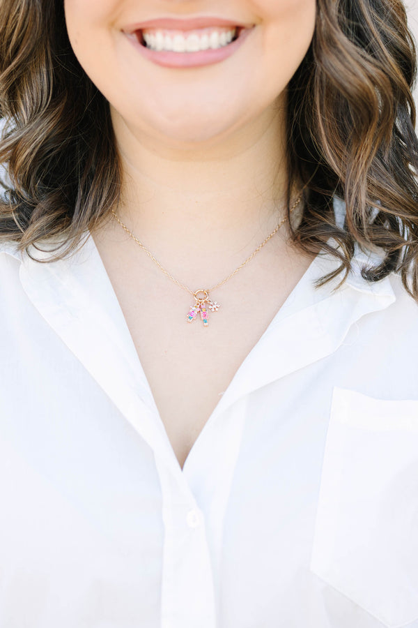 Clara’s Christmas Necklace in gold with nutcracker, ballerina, and snowflake charms.