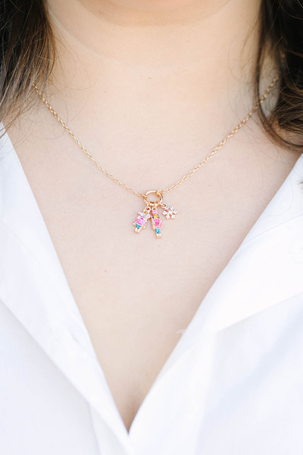 Clara’s Christmas Necklace in gold with nutcracker, ballerina, and snowflake charms.