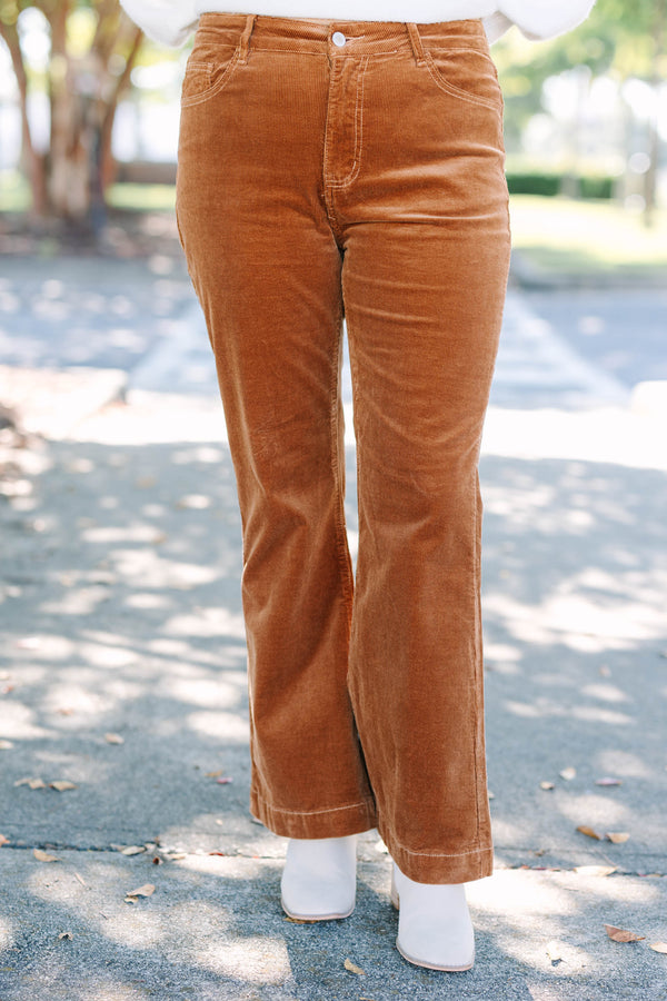 Plus size brown corduroy pants with a high-waisted, wide-leg silhouette and stretchy cotton fabric.