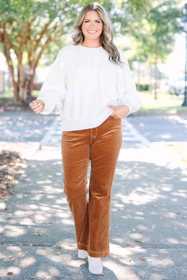 Plus size brown corduroy pants with a high-waisted, wide-leg silhouette and stretchy cotton fabric.